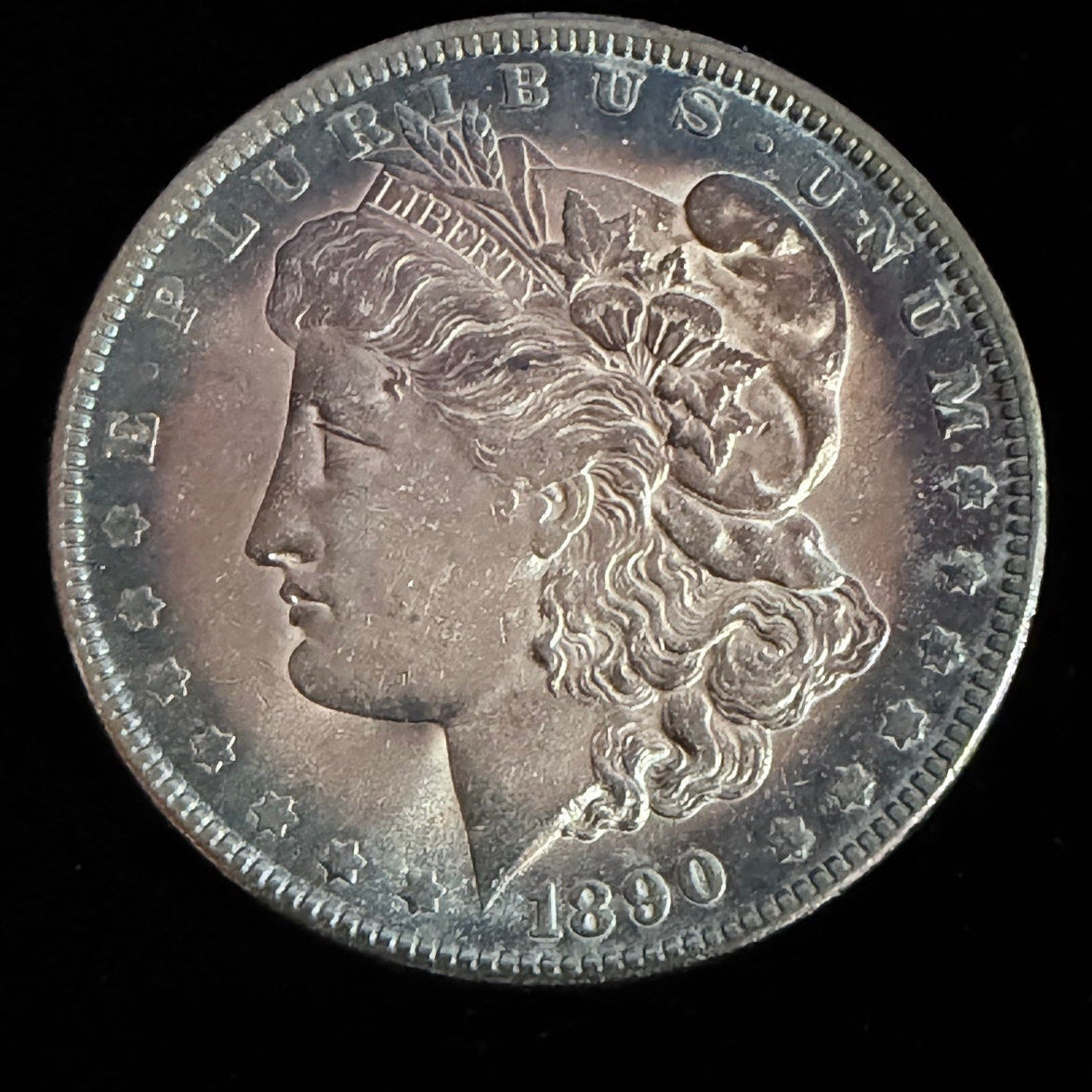 Silver Morgan Dollar coin from 1890 on a black background
