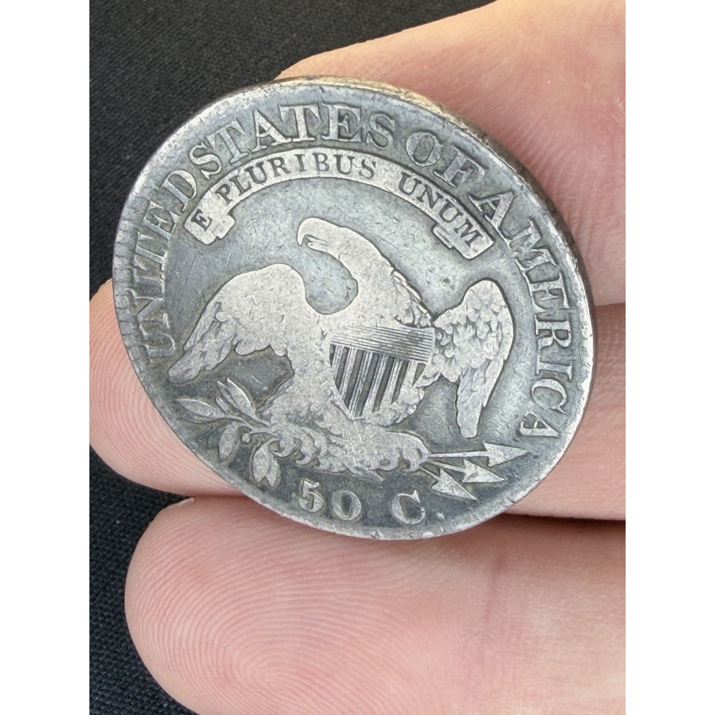 1824 4 Overdate Capped Bust Half Dollar reverse hand held view