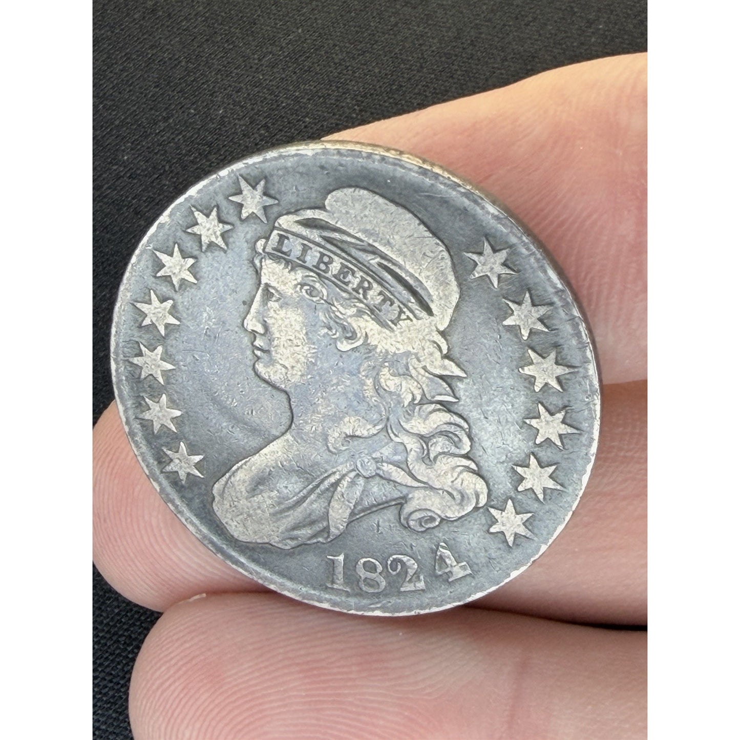 1824 4 Overdate Capped Bust Half Dollar obverse hand held view