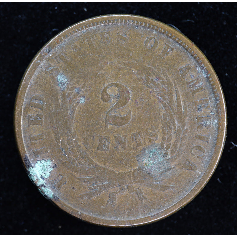 Obverse of 1864 United States Two Cent Piece with shield, heavy wear, and green environmental damage