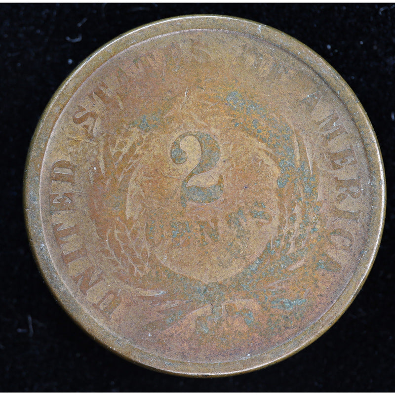 Obverse of 1864 United States Two Cent Piece with shield, heavy wear, and visible environmental damage