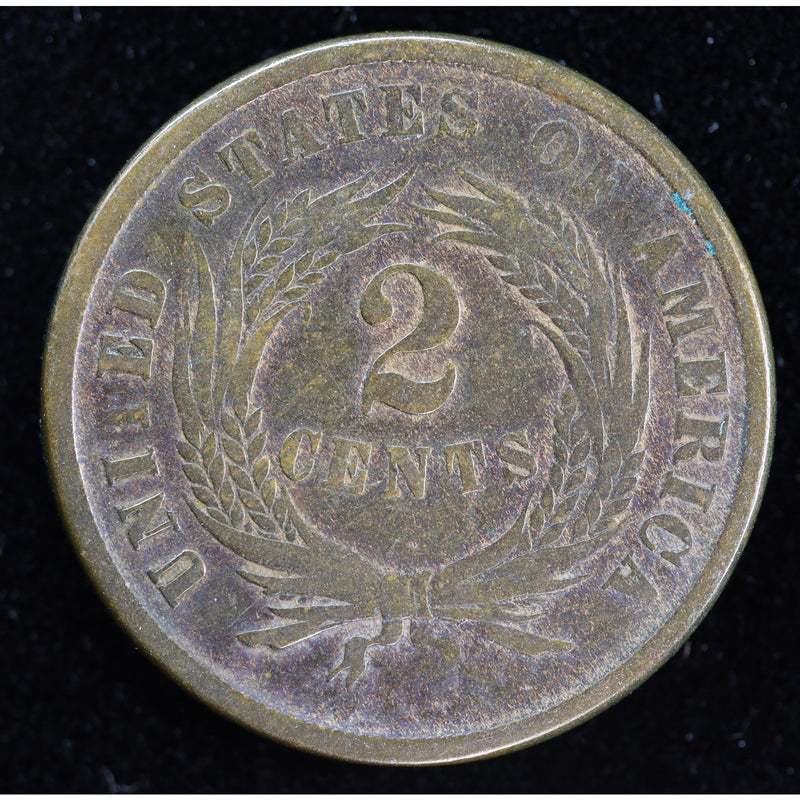 Obverse of dark-toned 1864 United States Two Cent Piece with shield and IN GOD WE TRUST motto